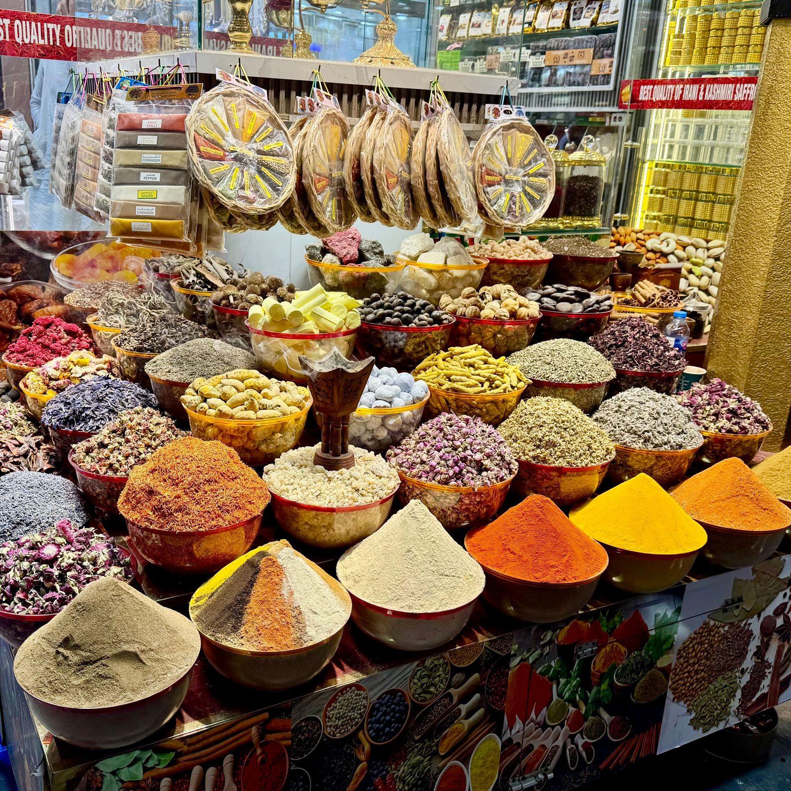 A market stand covered in bowls of spices